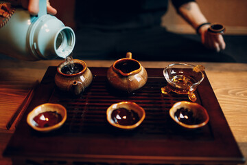 Obraz na płótnie Canvas Chinese traditional puerh tea ceremony. Shepherd, chahay and gaiwan pour water
