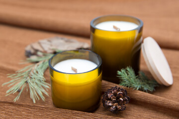Fototapeta na wymiar Scented candles for relax with a coniferous composition. Space for text.