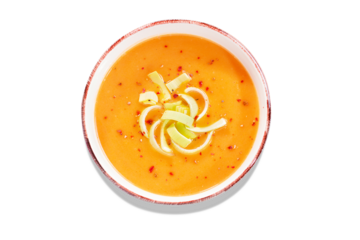 Isolated pumpkin or carrot cream soup with spices. Closeup of autumn spicy soup, healthy eating, top view