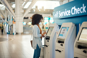 Fototapeta na wymiar Black woman, airport and self service kiosk for check in, ticket registration or online boarding pass. African female traveler by terminal machine for travel application, document or booking flight