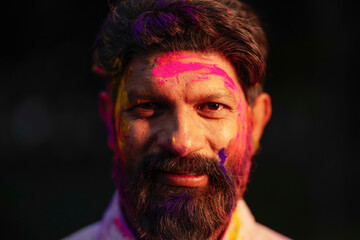 Close view of Indian man face covered with powder paint during Holi festival