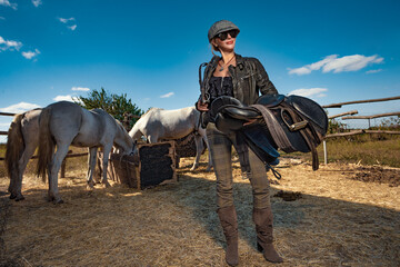 A Beautiful  adult woman outdoors with horse