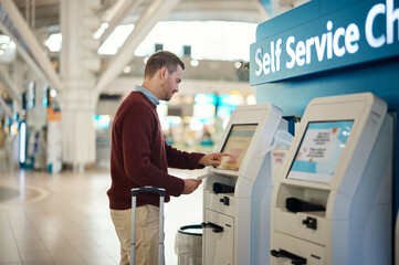 Plakat Man, airport and self service kiosk for check in, ticket registration or online boarding pass. Male traveler by terminal machine for travel application, document or booking flight with luggage