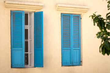 Fototapeta na wymiar Vintage blue wooden shutters on a windows of a house
