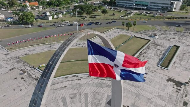 Aerial View Of Flag Square of Santo Domingo In The Dominican Republic Overlooking Daytime Traffic On The Road.