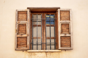 Vintage opened brown wooden shutters on a window