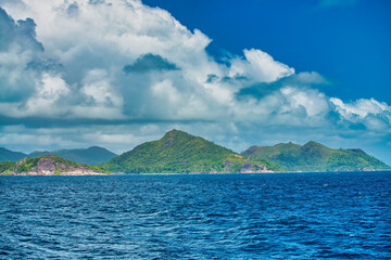 Mountains and vegetation of a beautiful tropical island as seen from the ocean