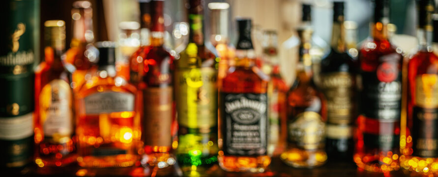 Beautiful bokeh from a row of alcoholic bottles in backlight.