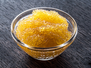 Pike caviar or roe in the bowl on wooden background.
