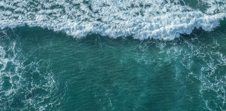 Ocean foamy pattern on water surface. Top view.