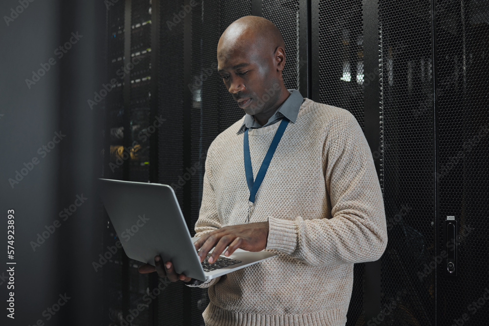 Poster Laptop, server room and black man or technician in data center management, system or cybersecurity. Analysis, serious or power coding solution, engineering programmer or information technology person