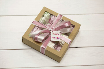 Homemade marshmallows in a cardboard box. Zephyr flowers. Gift wrap. Tied with ribbon.