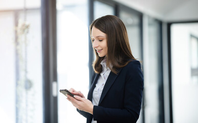 Fototapeta premium Working woman concept a female manager attending video conference and holding tablet, smatrphone and cup of coffee in office