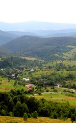 Obraz premium View of the village of Lipovets against the backdrop of the Ukrainian Carpathian mountains in the haze