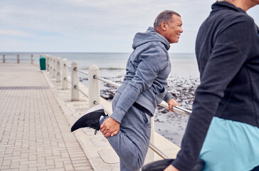 Stretching legs, exercise and senior couple by ocean for fitness, healthy body and wellness in...