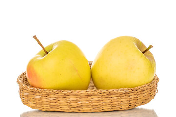 Two ripe juicy apples on a straw tray, macro, isolated on white background.