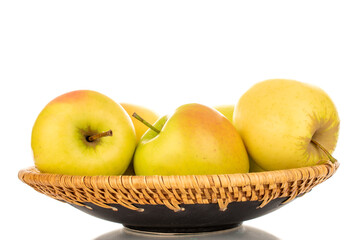 Several ripe juicy apples on a ceramic plate, macro, isolated on white background.
