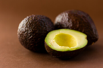 close up fresh avocados on brown background