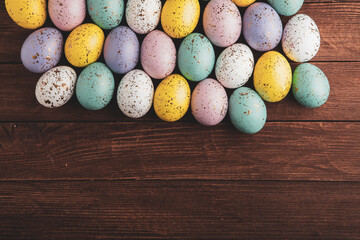 Fototapeta na wymiar banner. Easter frame with eggs and feathers on a blue wooden background. Minimal concept. View from above. Card with copy space for text.