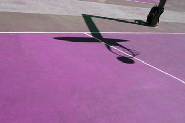 Fototapeta na wymiar shadows on the purple street basket court, purple background