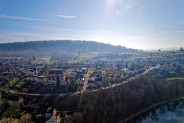 Scenic view of village of Feuerthalen with Cholfirst communications tower in the background on a sunny winter day. Photo taken February 16th, 2023, Schaffhausen, Switzerland.