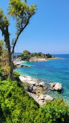 View of the sea surrounded by lush green trees. Saranda, Albania