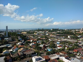aerial view of a distant downtown neighborhood with beautiful clouds and lots of trees