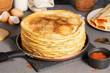 Traditional Russian pancakes with butter and red caviar