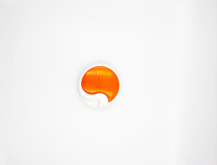 A round plastic box with a mirror and manicure tools inside