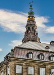 Fototapeta na wymiar Christiansborg Palace tower with blue sky and white clouds, Copenhagen, Denmark
