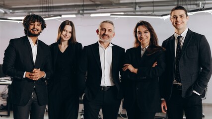 Successful businessmen and businesswomen standing together. Multiethnic business team smiling while posing in office. Career opportunities