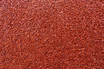 Close up of red rubber floor background. rubber flooring for sports and playgrounds, Running racetrack,  tennis court.