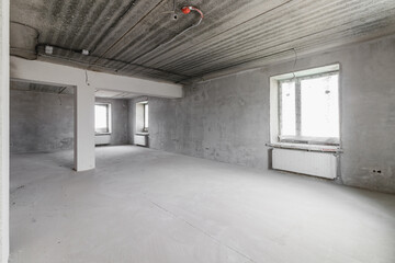 Spacious empty rooms floor after filling out the work on the wall and ceiling