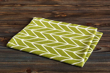 top view with green kitchen napkin isolated on table background. Folded cloth for mockup with copy space, Flat lay. Minimal style