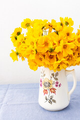 Beautiful summer flowers yellow Chamomile in a vase, part of home interior, Cota tinctoria