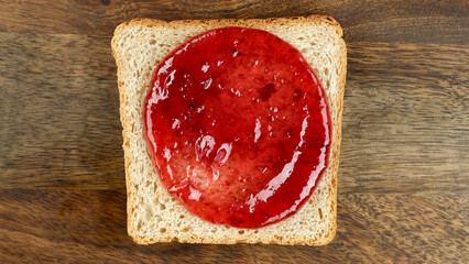 Raspberry jam on roasted toast bread