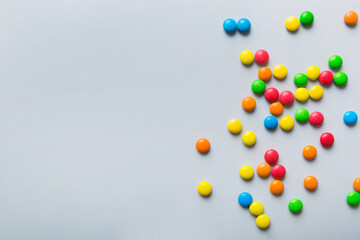 Mixed collection of colorful candy, on colored background. Flat lay, top view. frame of colorful chocolate coated candy