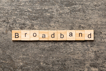BROADBAND word written on wood block. BROADBAND text on table for your desing, concept