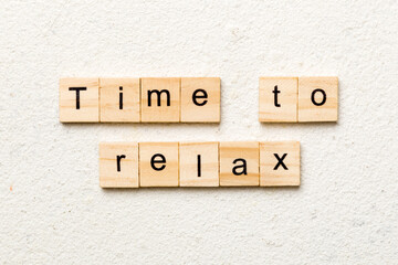 time to relax word written on wood block. time to relax text on table, concept