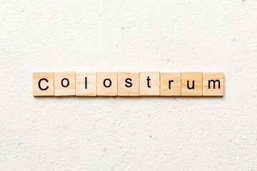 colostrum word written on wood block. colostrum text on table, concept