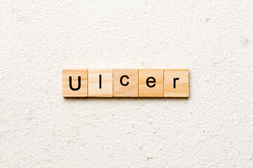 ulcer word written on wood block. ulcer text on table, concept
