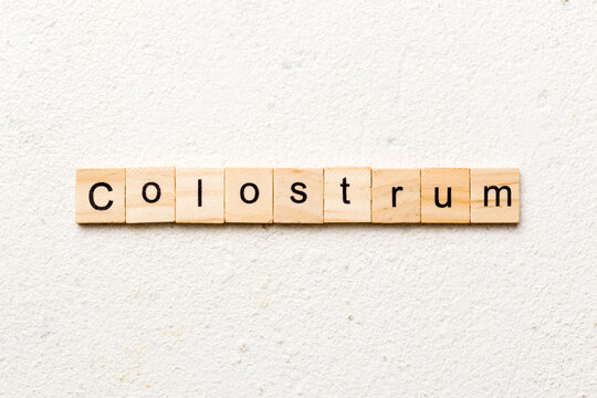 colostrum word written on wood block. colostrum text on table, concept