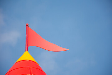 Plastic flag on top of a castle or fort for children in a park.