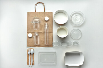 Various disposable tableware bottles and containers on a white background