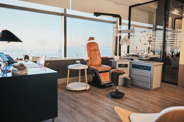 Optometry, equipment and empty office of a doctor for work in ophthalmology, eye and vision care. Healthcare, surgery and room at a clinic for optician workspace, optometrist business and furniture