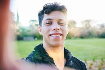 Man, selfie and smile at outdoor park in summer for walk, wellness and portrait by blurred...