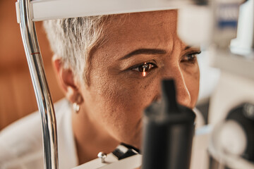 Laser, vision or senior customer in eye exam for eyesight at optometrist office in assessment or consultation. Face of mature woman testing or checking vision to help iris or retina visual health - obrazy, fototapety, plakaty