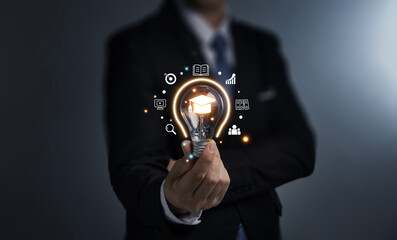 Education and E-learning concept, Webinar online, Hand of man holding lightbulb showing graduation...