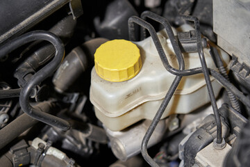 car brake fluid reservoir and brake system pipes going to ABS