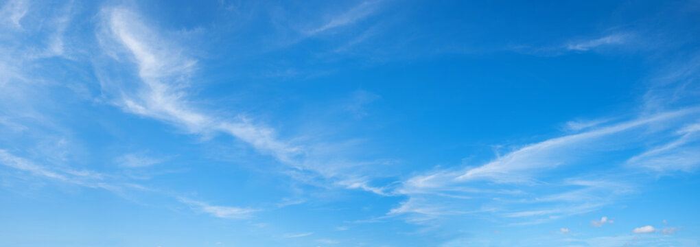 blue sky panorama with feathery cirrus clouds and copy space, windy weather